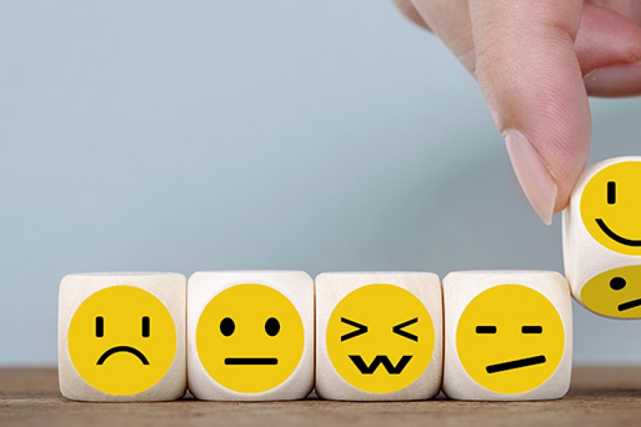 Hand Changing with smile emoticon icons  face on Wooden Cube , hand flipping unhappy turning to happy symbol