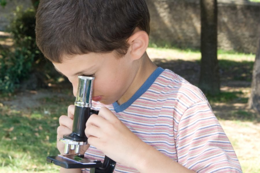 schoolboy with microscope