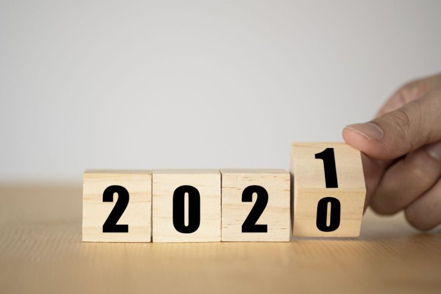 Hand flipping wooden blocks for change year  2020 to 2021 . New year and holiday concept.